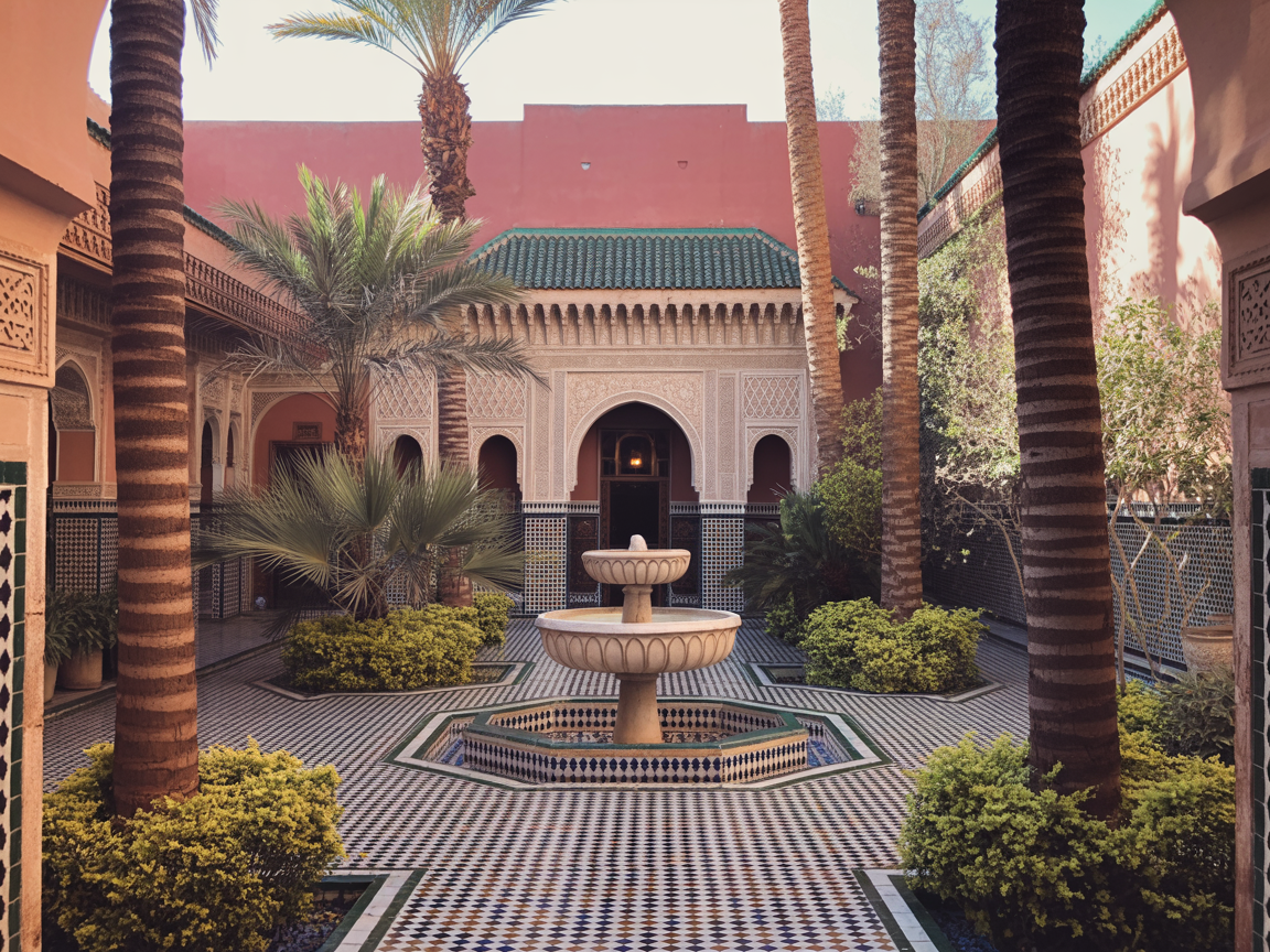 Luxury Moroccan riad courtyard with ornate fountain and palm trees